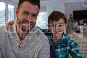 Happy father and son in living room