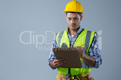 Male architect writing on clipboard