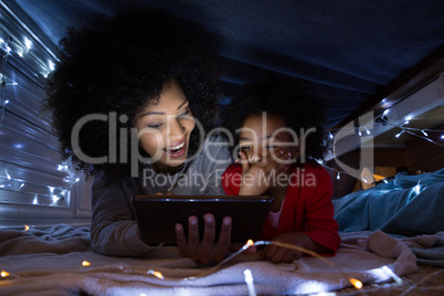 Mother and daughter using digital tablet