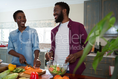 Couple preparing salad in the kitchen