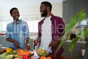 Couple preparing salad in the kitchen