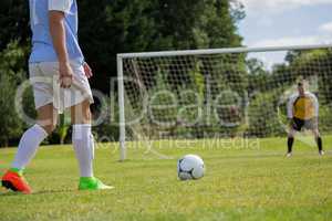 Soccer player is ready to kick ball from penalty spot