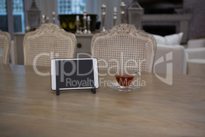 Digital tablet and lemon tea on dining table