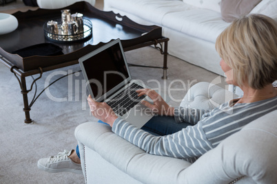 Woman using laptop in living room