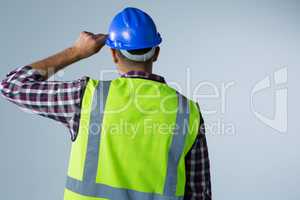 Male architect standing against white background