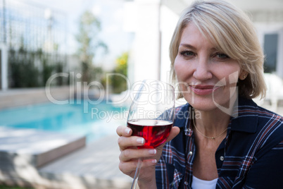 Beautiful woman holding glass of red wine