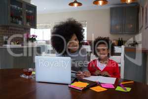 Mother helping her daughter in her studies