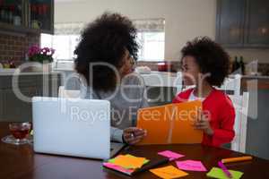 Mother helping her daughter in her studies