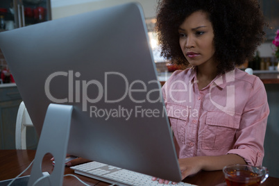 Woman using computer at home