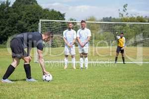 Soccer player is ready to kick ball from penalty spot