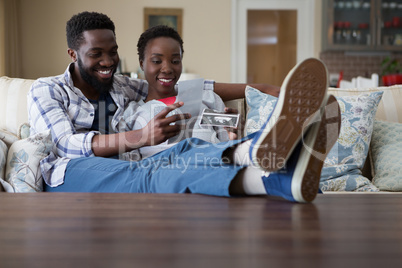 Couple looking at sonography in living room