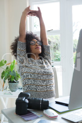 Graphic designer stretching her arms