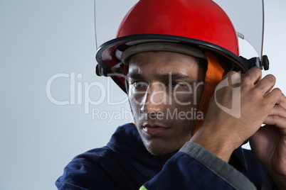 Fireman adjusting his safety helmet