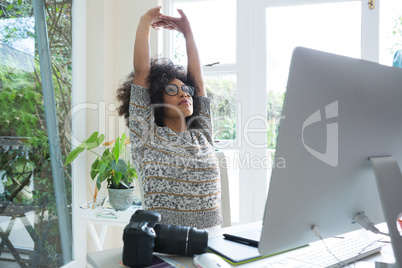 Graphic designer stretching her arms