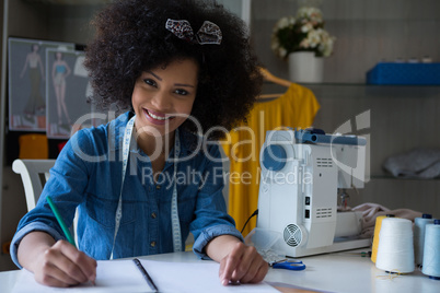 Female fashion designer working at desk