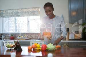 Beautiful woman chopping vegetables in kitchen