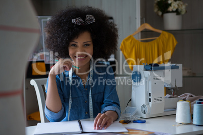 Female fashion designer working at desk