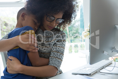 Mother embracing her son at home