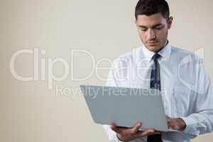 Executive using laptop against white background