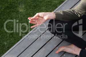 Low section of woman practicing yoga in porch