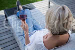 Woman having wine in porch