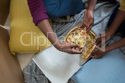 Couple having pizza in new house