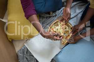 Couple having pizza in new house