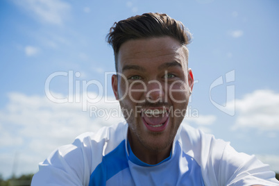 Excited football player looking at camera