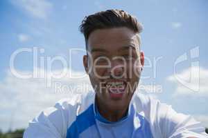 Excited football player looking at camera