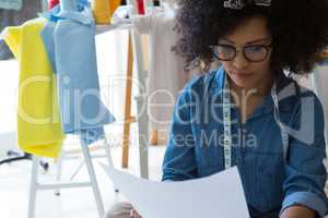 Female fashion designer looking at sketch