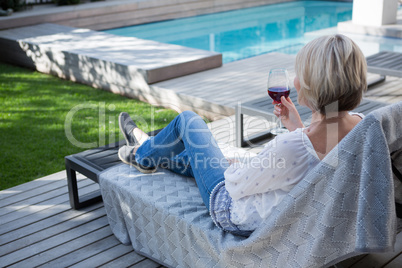 Woman having wine in porch