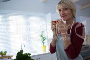 Portrait of happy woman having lemon tea