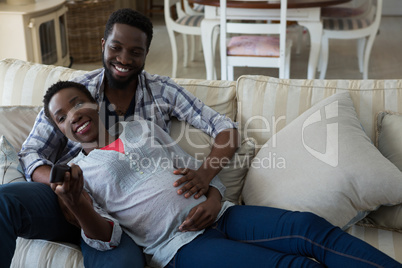 Couple watching television together in living room