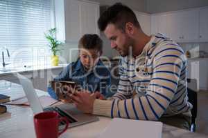 Father assisting daughter in her studies