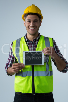 Male architect showing digital tablet against white background