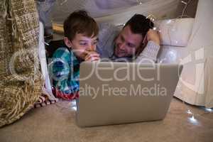 Father and son using laptop