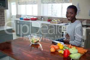 Portrait of beautiful woman standing in kitchen