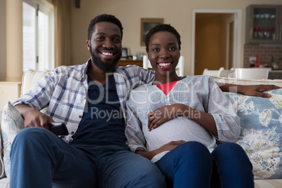 Couple watching television together in living room