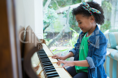 Adorable girl playing piano