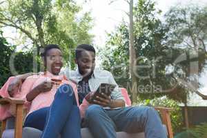 Couple using digital tablet in garden