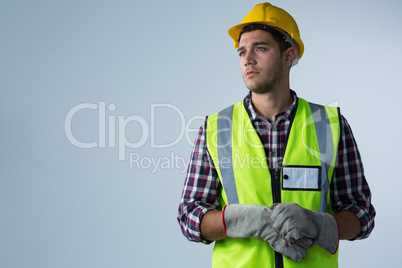 Male architect standing against white background