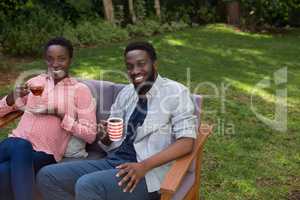 Couple having lemon tea and black coffee in garden