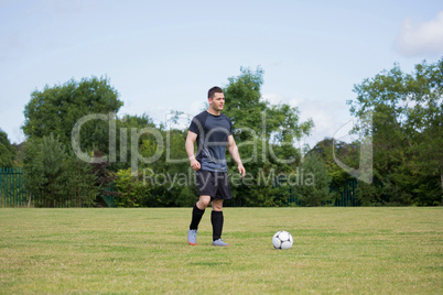 Football player playing soccer in the ground