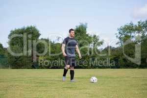 Football player playing soccer in the ground