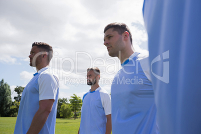 Football players standing in ready position