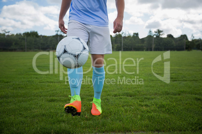 Football player juggling soccer ball