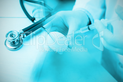 Composite image of stethoscope on desk