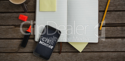 Composite image of organizer, coffee, mobile phone and stationery on wooden plank