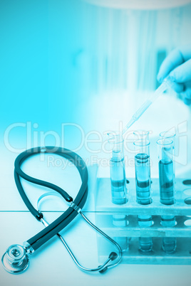 Composite image of stethoscope on desk