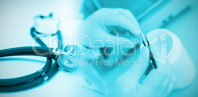 Composite image of stethoscope on desk